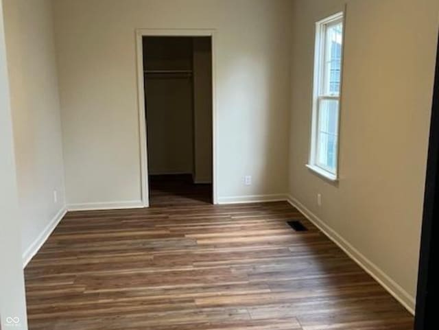 223 E Fordice St, Lebanon, IN 46052 - unfurnished bedroom featuring wood finished floors, baseboards, and multiple windows