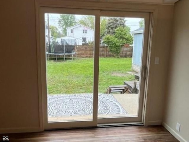 223 E Fordice St, Lebanon, IN 46052 - doorway to outside featuring baseboards and wood finished floors