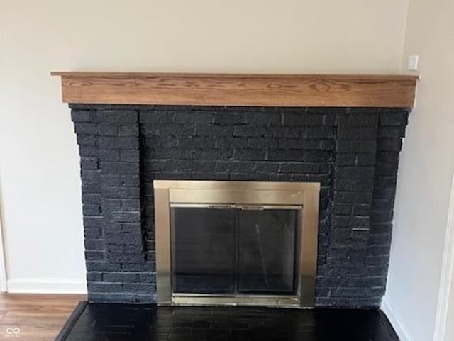 223 E Fordice St, Lebanon, IN 46052 - interior details with baseboards, a glass covered fireplace, and wood finished floors