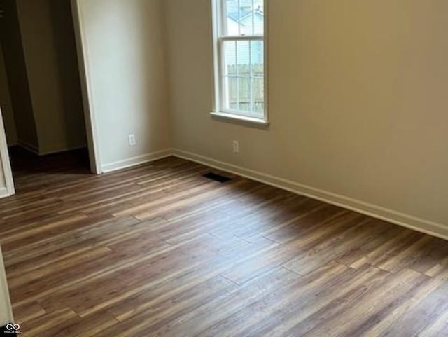 223 E Fordice St, Lebanon, IN 46052 - empty room with dark wood-style flooring, baseboards, and visible vents