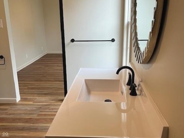 223 E Fordice St, Lebanon, IN 46052 - bathroom with wood finished floors, baseboards, and a sink