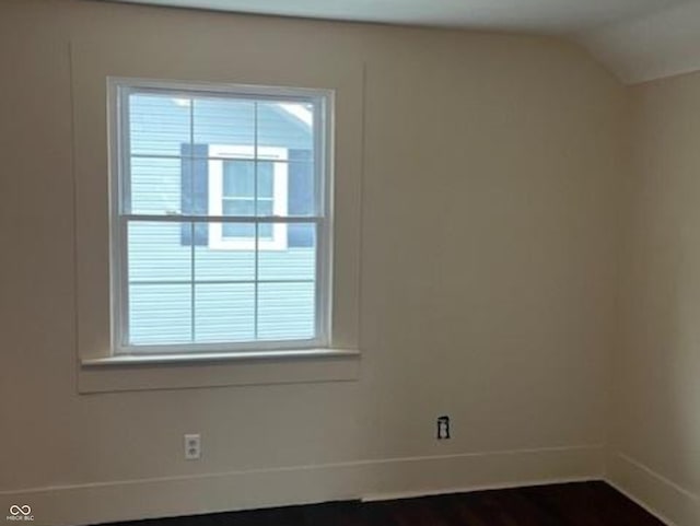 223 E Fordice St, Lebanon, IN 46052 - unfurnished room with baseboards, a healthy amount of sunlight, dark wood-style floors, and vaulted ceiling