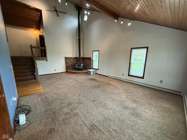 7140 N Michigan Rd, Fairland, IN 46126 - unfurnished living room featuring wooden ceiling, carpet, stairway, a baseboard radiator, and a wood stove