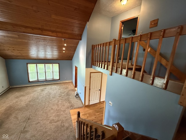 7140 N Michigan Rd, Fairland, IN 46126 - stairway with vaulted ceiling, wood ceiling, carpet, baseboards, and ceiling fan