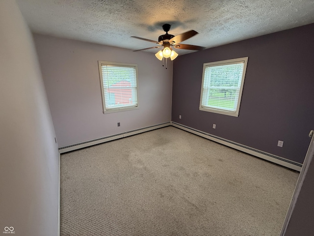 7140 N Michigan Rd, Fairland, IN 46126 - spare room featuring ceiling fan, a textured ceiling, a baseboard radiator, carpet, and baseboards