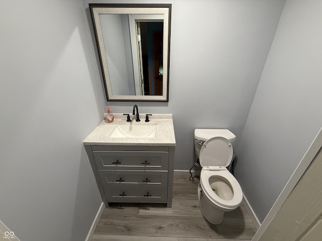 7140 N Michigan Rd, Fairland, IN 46126 - bathroom with vanity, toilet, wood finished floors, and baseboards