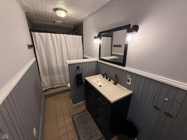 7140 N Michigan Rd, Fairland, IN 46126 - bathroom featuring vanity, toilet, wainscoting, curtained shower, and tile patterned flooring