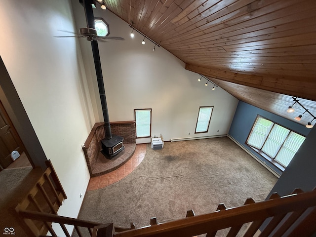 7140 N Michigan Rd, Fairland, IN 46126 - additional living space featuring wood ceiling, a wood stove, vaulted ceiling, carpet, and ceiling fan