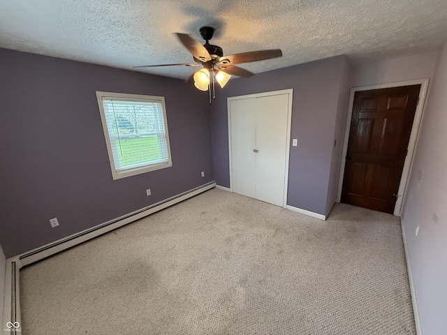 7140 N Michigan Rd, Fairland, IN 46126 - unfurnished bedroom featuring a baseboard heating unit, baseboards, light carpet, a closet, and a textured ceiling