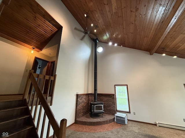 7140 N Michigan Rd, Fairland, IN 46126 - unfurnished living room featuring a baseboard radiator, wooden ceiling, a wood stove, high vaulted ceiling, and stairs