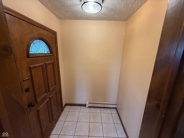 7140 N Michigan Rd, Fairland, IN 46126 - foyer featuring baseboard heating, a textured ceiling, light tile patterned floors, and baseboards