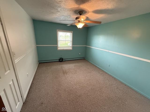 7140 N Michigan Rd, Fairland, IN 46126 - carpeted empty room with a baseboard radiator, a textured ceiling, a ceiling fan, and baseboards