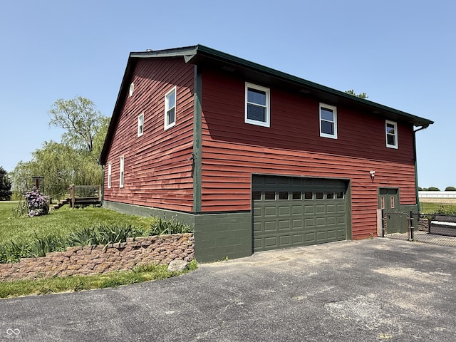 7140 N Michigan Rd, Fairland, IN 46126 - view of side of home featuring an attached garage and driveway