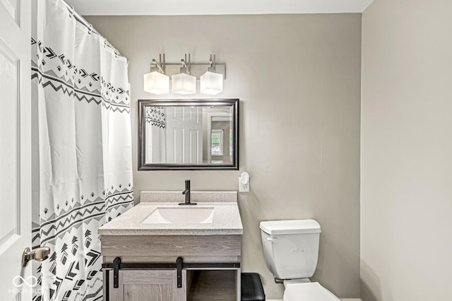 bathroom featuring toilet and vanity