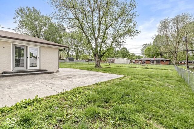 view of yard featuring a patio and fence
