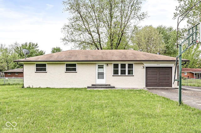 ranch-style house featuring brick siding, fence, a garage, and aphalt driveway