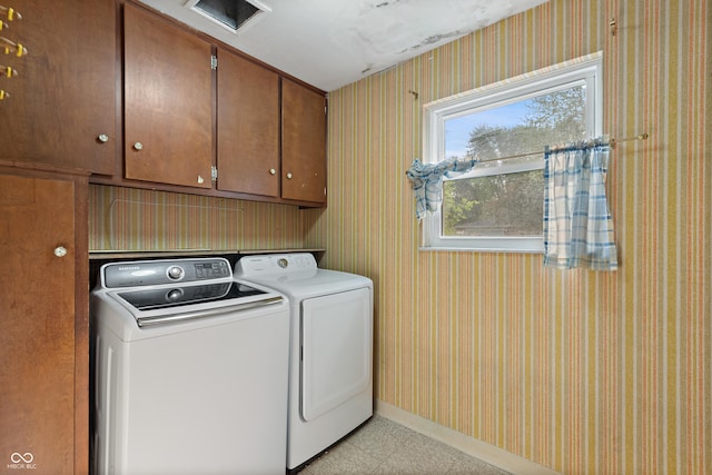 laundry room with washer and dryer, baseboards, wallpapered walls, and cabinet space
