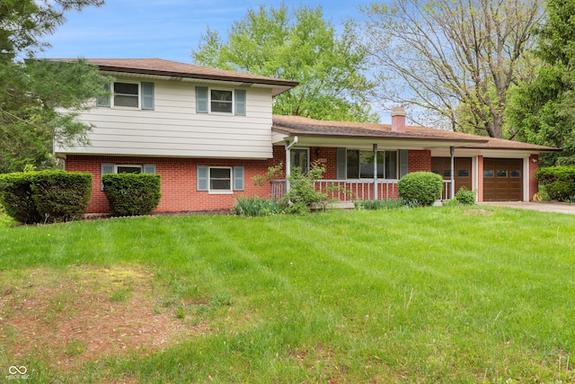 split level home with a front lawn, a chimney, brick siding, an attached garage, and a porch