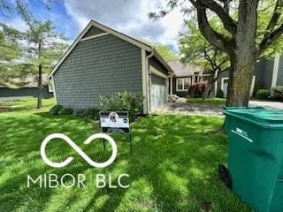 view of home's exterior featuring a garage and a lawn