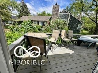 wooden terrace with outdoor dining area