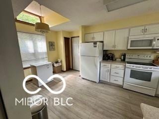 kitchen featuring light wood finished floors, light countertops, white cabinets, and white appliances