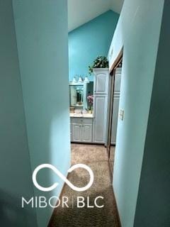 hallway with vaulted ceiling