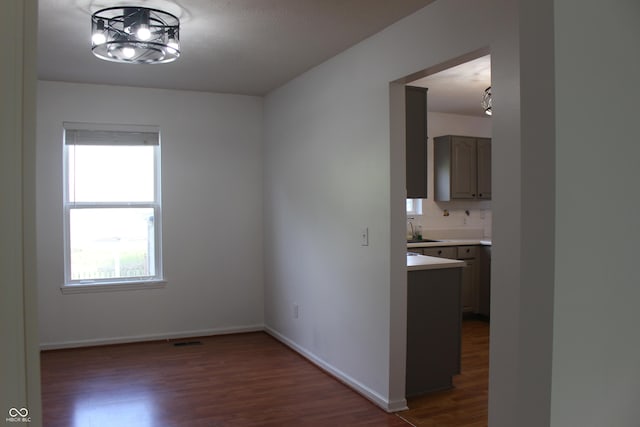 8551 Walden Trace Dr, Indianapolis, IN 46278 - unfurnished room with dark wood finished floors, baseboards, and a chandelier