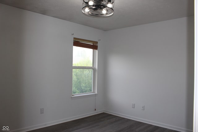 8551 Walden Trace Dr, Indianapolis, IN 46278 - spare room featuring dark wood-style floors, healthy amount of natural light, a chandelier, and baseboards