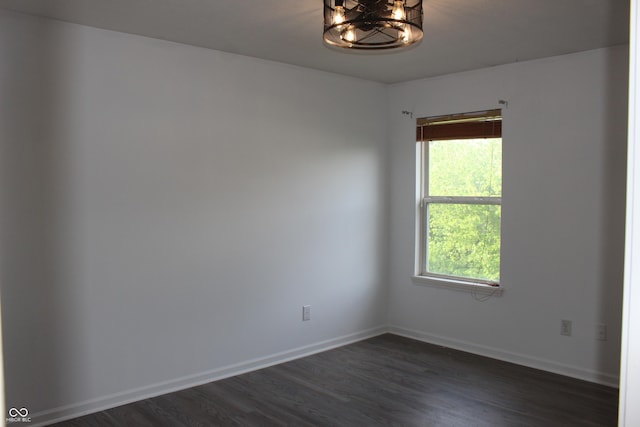 8551 Walden Trace Dr, Indianapolis, IN 46278 - spare room featuring dark wood-style floors, a chandelier, and baseboards
