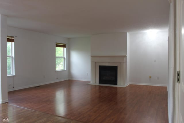 8551 Walden Trace Dr, Indianapolis, IN 46278 - unfurnished living room featuring wood finished floors, a tile fireplace, and baseboards