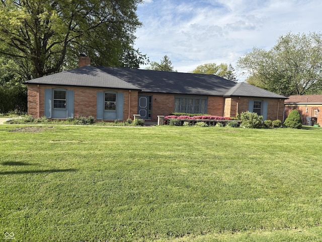 3128 W 12th St, Anderson, IN 46011 - ranch-style home featuring brick siding, a front yard, and a chimney
