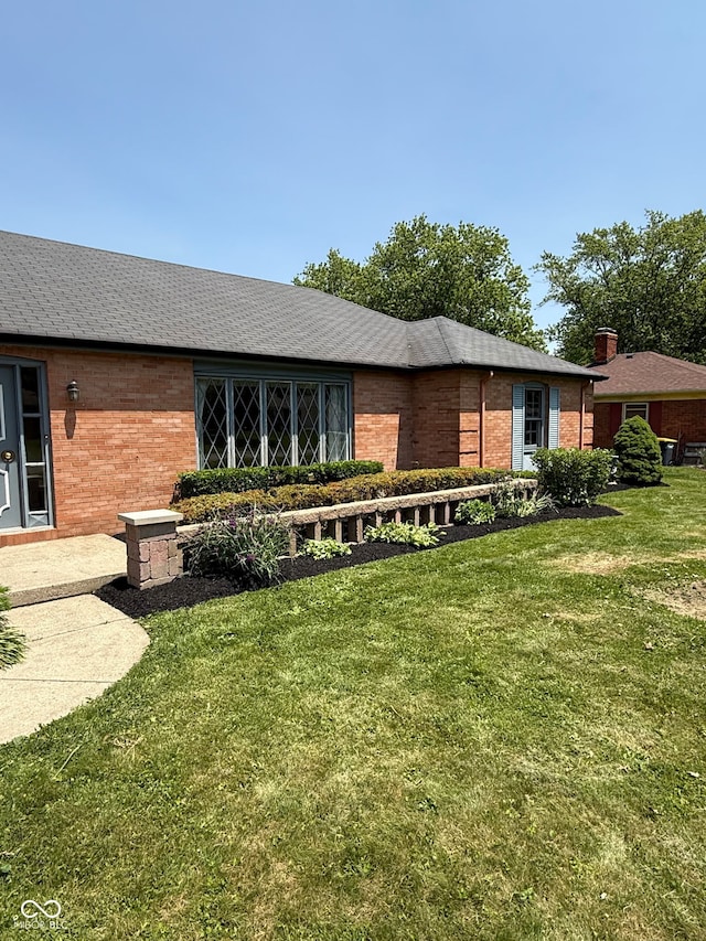 3128 W 12th St, Anderson, IN 46011 - back of property with brick siding and a lawn