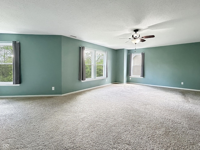 625 Streamside Dr, Greenfield, IN 46140 - spare room with a textured ceiling, carpet, plenty of natural light, and a ceiling fan