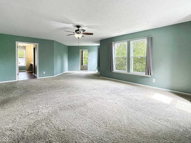 625 Streamside Dr, Greenfield, IN 46140 - spare room featuring a ceiling fan, carpet floors, baseboards, and a textured ceiling