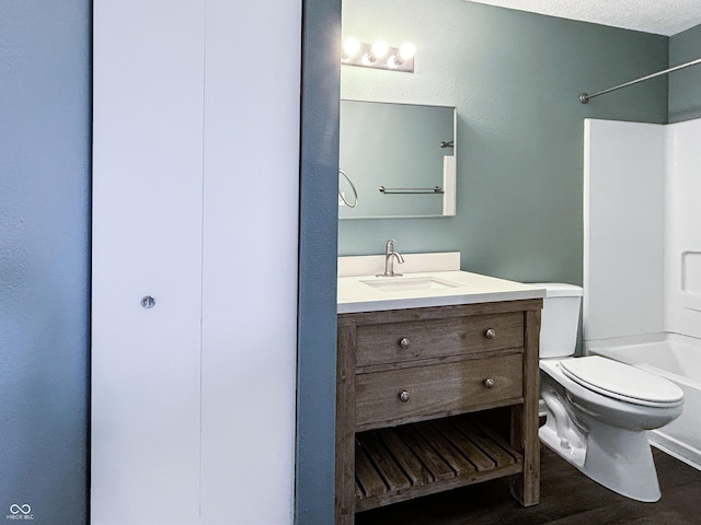 625 Streamside Dr, Greenfield, IN 46140 - bathroom featuring toilet, vanity, bathtub / shower combination, and wood finished floors