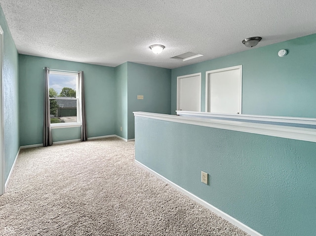 625 Streamside Dr, Greenfield, IN 46140 - spare room with a textured ceiling, carpet, and baseboards