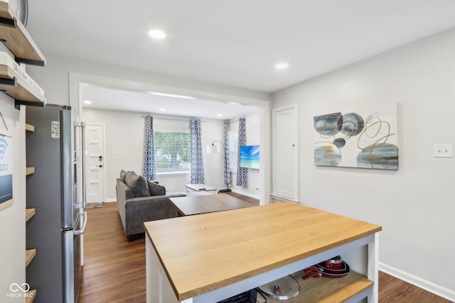 dining space with baseboards, dark wood finished floors, and recessed lighting