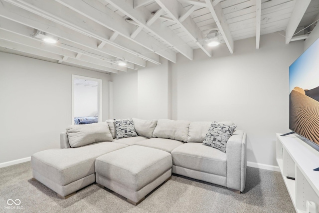 living room with carpet flooring, baseboards, and beam ceiling