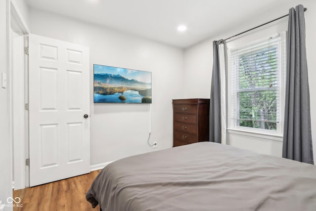 bedroom featuring recessed lighting and wood finished floors