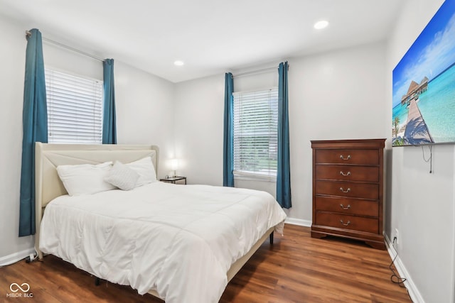 bedroom with wood finished floors, baseboards, and recessed lighting