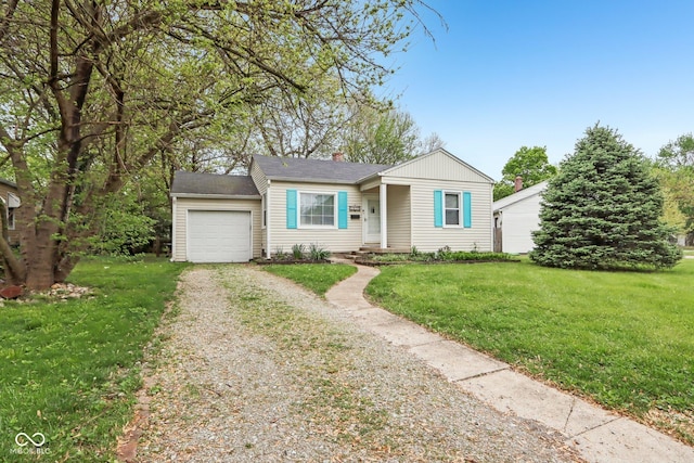 view of front of property with a chimney, driveway, a garage, and a front yard
