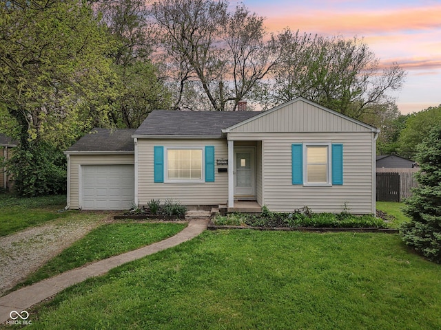 view of front of home featuring a yard, a chimney, fence, dirt driveway, and a garage