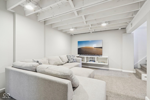 carpeted living area featuring stairway and baseboards