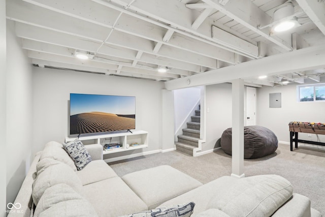 living area featuring baseboards, stairway, carpet, and electric panel