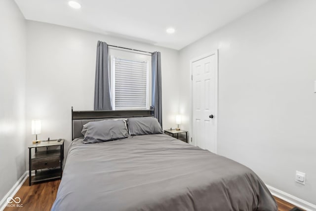 bedroom with recessed lighting, baseboards, and wood finished floors