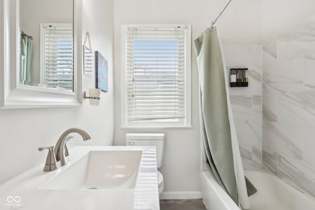 bathroom featuring toilet, shower / tub combo, and vanity