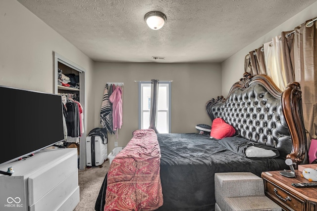 bedroom with carpet flooring, a closet, and a textured ceiling