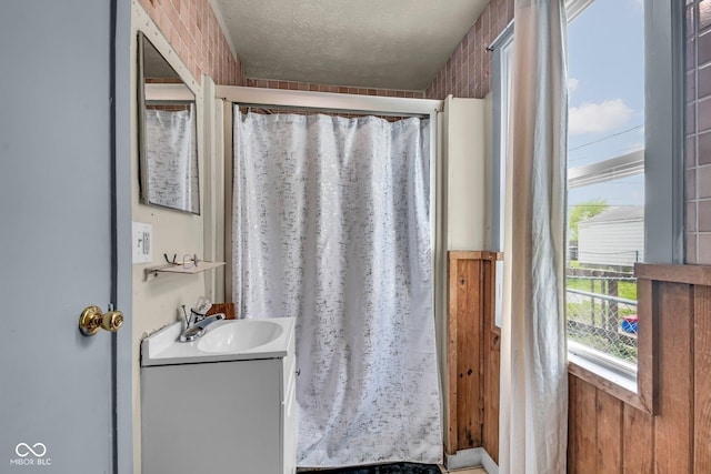 bathroom with vanity, a textured ceiling, and a shower with shower curtain