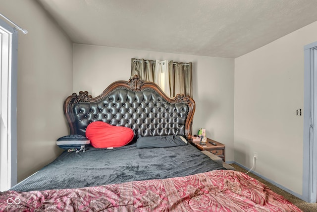bedroom featuring carpet flooring and baseboards