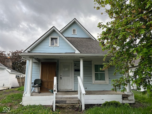 view of front of house with a porch and a shingled roof